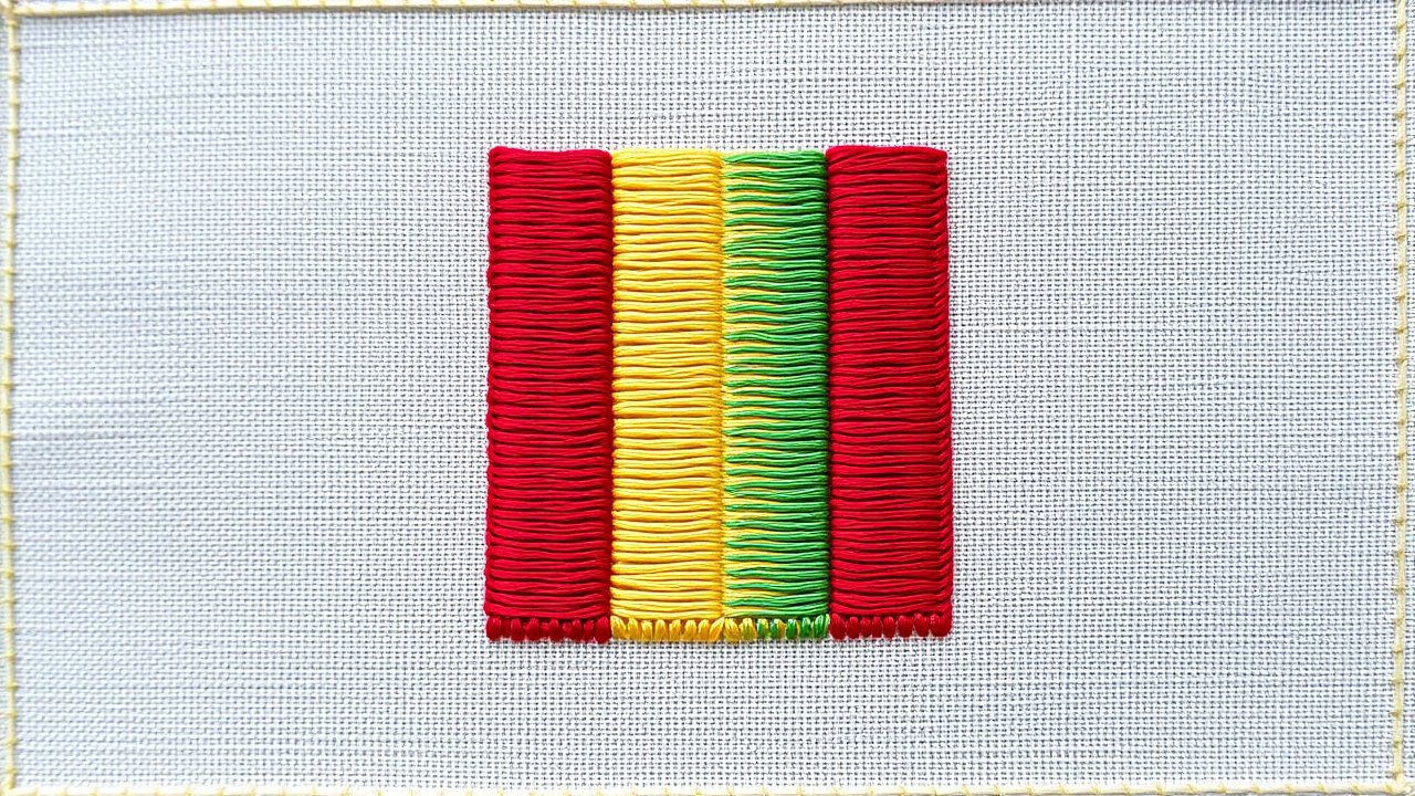 Flag of Guinea 🇬🇳 in embroidered textile style