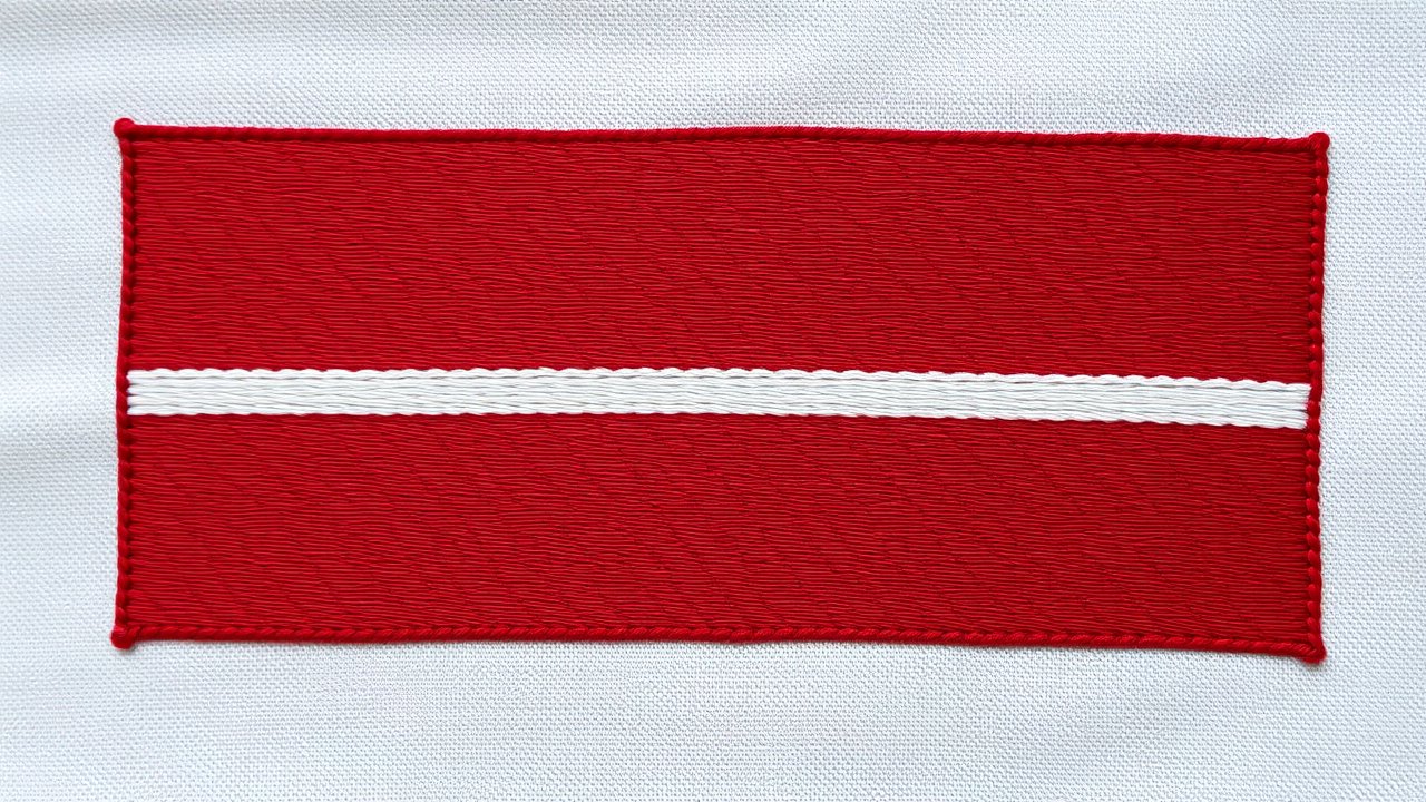 Flag of Latvia 🇱🇻 in embroidered textile style