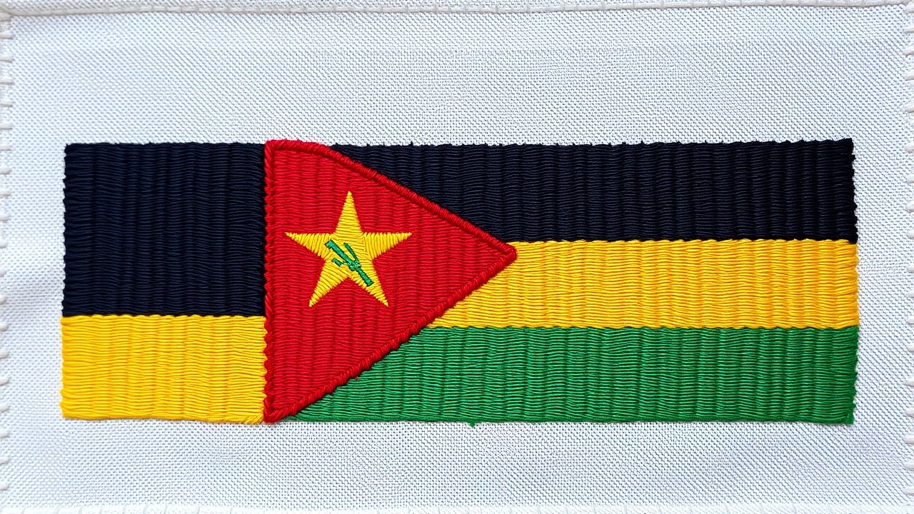 Flag of Mozambique 🇲🇿 in embroidered textile style